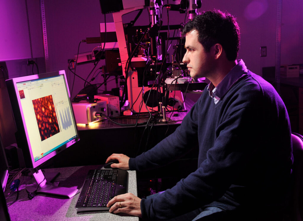 scientist looking at cells image on a computer